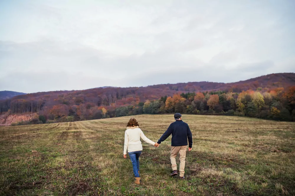 couple walking in field couple walking in field