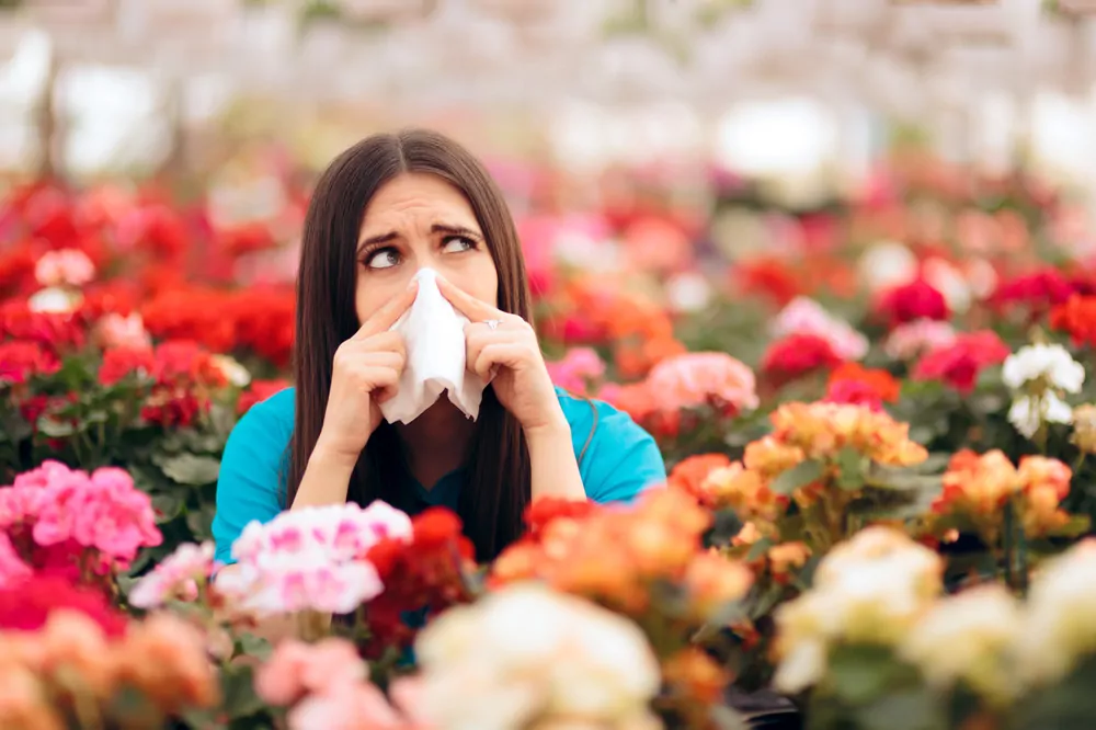 woman with allergies in flowers